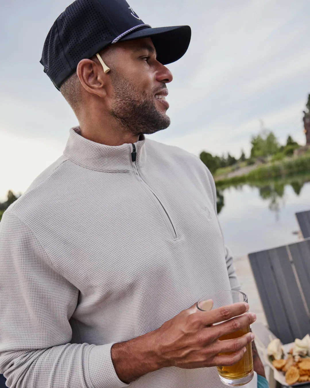 Man in a dove-grey waffle quarter-zip outdoors
