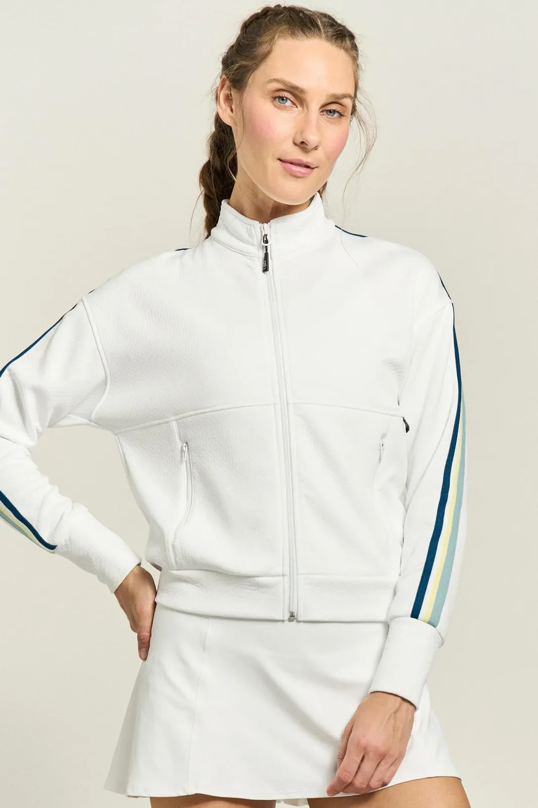 Woman in the white Zone jacket with blue and green sleeve stripes